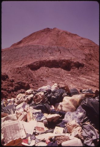 ABANDONED MINE IN LADD IS USED AS CITY DUMP. THE GARBAGE IS COVERED WITH CLAY