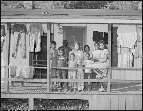 Front porch and family of Furman Currington, miner, who lives in company housing project. Two of family are not in... -…