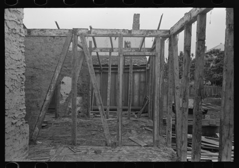 Side wall of old house dating from early nineteenth century showing details of construction. Showing use of mud and mos…