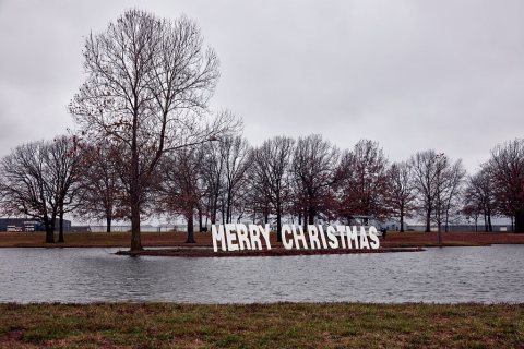 Passersby on the main road between Springfield and Branson, Missouri, get a Christmas greeting along a lake at the Trac…