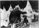 Presbyterian pastor in Klan robes praises Jewish merchant and Klan presents flowers to him in [sic] his golden business…