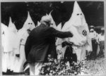 Presbyterian pastor in Klan robes praises Jewish merchant and Klan presents flowers to him in [sic] his golden business…