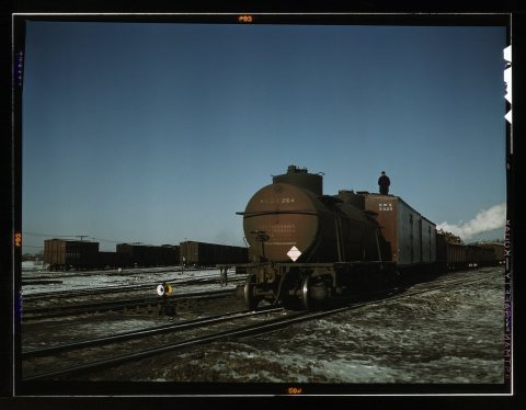 A train (or "cut") being pushed out of a receiving yard toward the hump. A brakeman rides each train to signal the engi…
