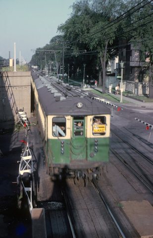 CTA Westbound Lake Street L approaching the Oak Park Ave. station while crossing the Euclid Ave. grade crossing in Oak …