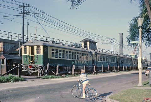 CTA Eastbound Lake St. "L" going past the pedrestrain-only frade crossing at Elmwood Ave in Oak Park, IL on August 14, …