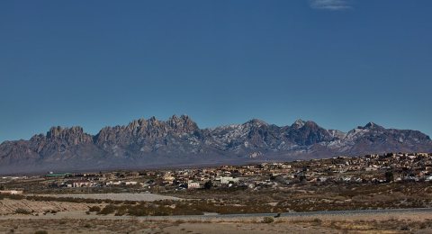 A distant view of Tortugas, New Mexico, a community at the base of the Organ Mountain Range below Las Cruces