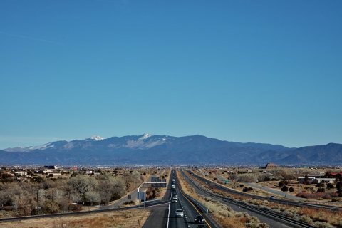 View of U.S. Interstate Highway 25 in the vast valley southwest of Santa Fe, New Mexico, near the settlement of Los Cer…