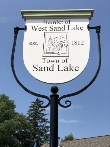 2024-06-20 14 48 46 Sign for the hamlet of West Sand Lake at the intersection of New York State Route 43 and New York S…