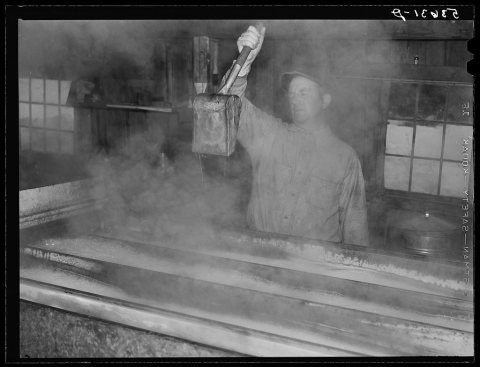 Walter M. Gaylord dripping the boiled-down maple sap to see if it has reached correct consistency. Waitsfield, Mad Rive…