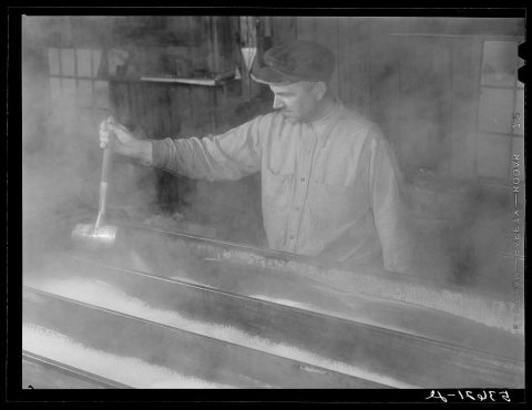 Untitled photo, possibly related to: Walter M. Gaylord dripping the boiled-down maple sap to see if it has reached corr…
