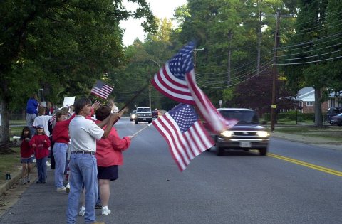 In a patriotic show of support, students and teachers from Byrd Elementary School, in Sandston, Virginia, stand outside…
