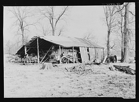 Machine shed on William Weltis' farm near Boswell, Indiana. This fourteen hundred acre farm is owner-operated. Under a …