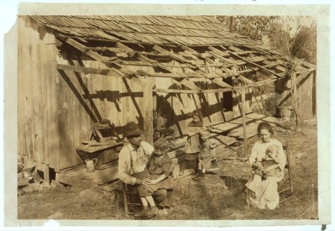 Frank Burditt and family. They rent this dilapidated shank [i.e., shack] and are trying to make a living off the meagre…