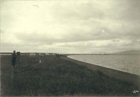 Man with box camera on tripod on the beach, Teller, Alaska, ca. 1900