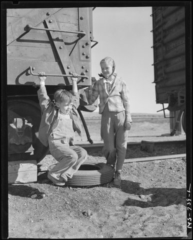 Child of miner swinging on box car home of company housing project. Union Pacific Coal Company, Reliance Mine... - NARA…