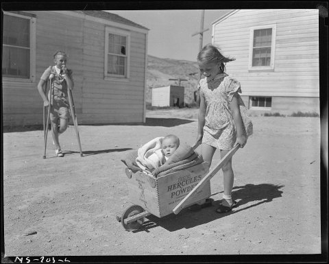 Children of miner living in company housing project. Note the homemade baby buggy made of a powder box. Union Pacific..…