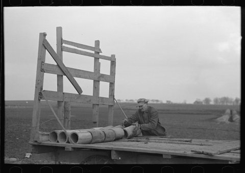 Tip Estes loading tile on a wagon