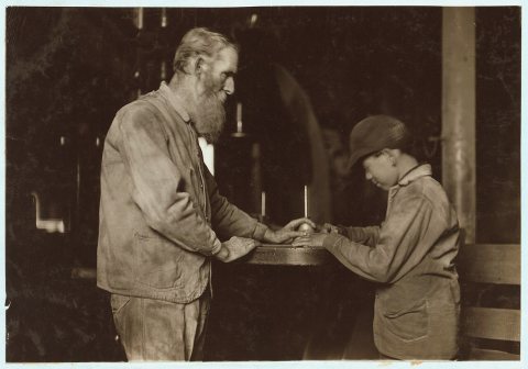 Indiana Mfg. Co. Peru, Ind. The old and the new. Old man has been there 33 years. Boy starting in, working with a board…