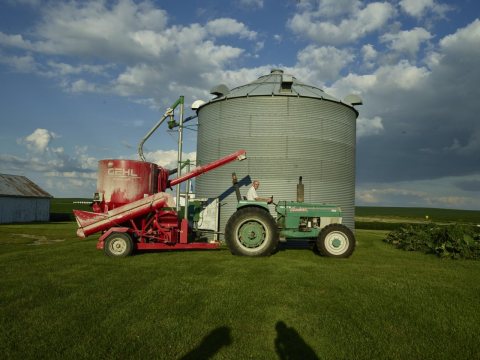 Dean Folkmann operates the family tractor on his and his wife, Julie's, hog farm in Benton County, near Newhall, Iowa