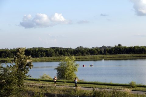 Rowers and joggers enjoy a summer day at Grundy County Lake near the town of Dike, Iowa