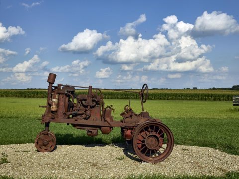 Rusted remains of a vintage tractor at the Hardin County Farm Museum, a farm site