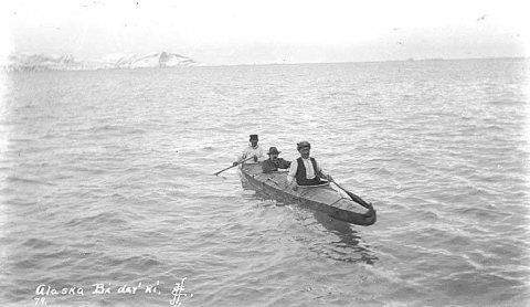 Three natives in bidarki, or skin covered boat on Cold Bay, ca. 1912