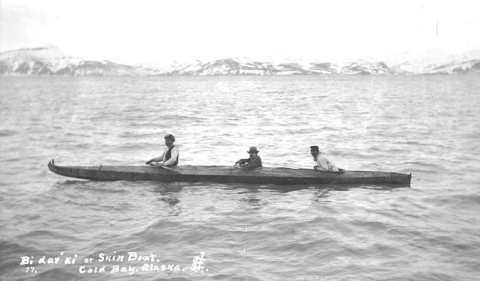Three natives in a bidarki or skin covered boat on Cold Bay, ca. 1912