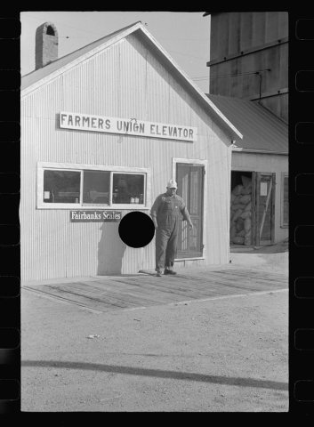 Untitled photo, possibly related to: Unloading feed at Farmer's Union Coop elevator