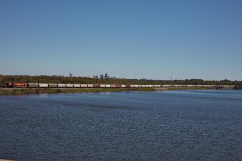 A long train passes Cross Lake near Blanchard, Louisiana