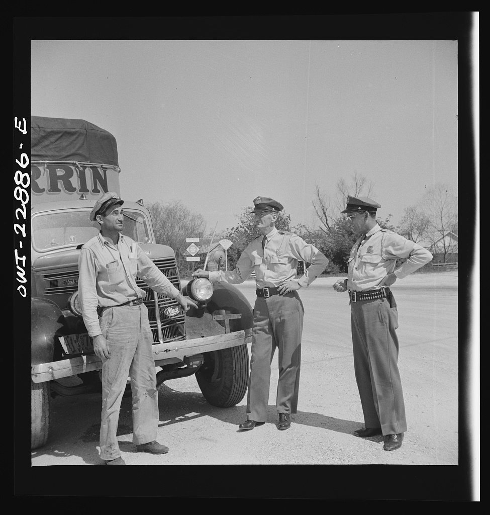 Franklin, Louisiana. State highway patrolmen talking with Jean Broussard, a Cajun truck driver