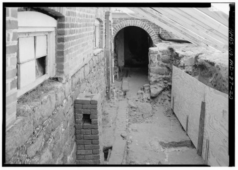 EXCAVATION OF EAST (FRONT) BASEMENT WELL AND DRAINAGE SYSTEM, WITH ARCHED ENTRY INTO BASEMENT UNDER FRONT ENTRY IN BACK…