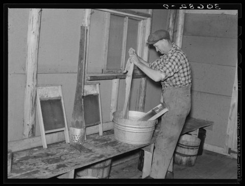 Lumberjack washing clothes. Camp near