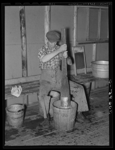 Lumberjack washing clothes at logging camp near