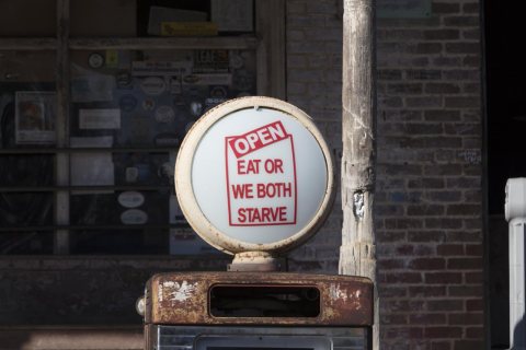 Detail of a sign atop an old gas pump