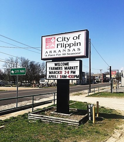 Sign outside of city hall in downtown Flippin advertising local events