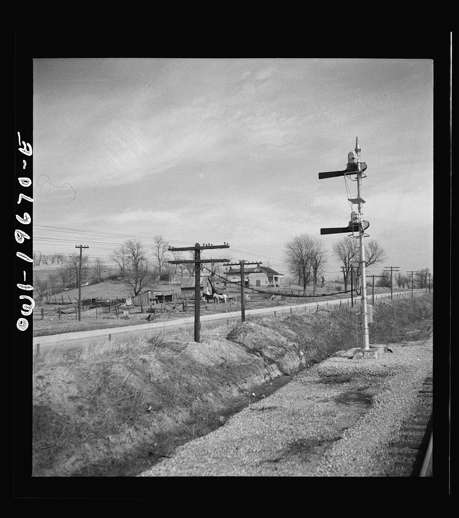 Camden (vicinity), Missouri. A farmstead along the right of way on the Atchison, Topeka, and Santa Fe Railroad between …