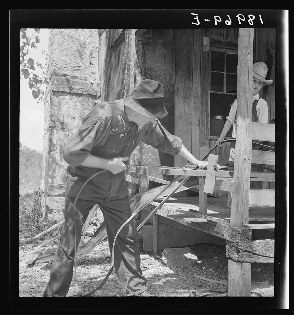 In Arkansas Hills (Ozarks) near Seligman, Missouri, splitting hickory for chair-bottoms. His father before him and his …