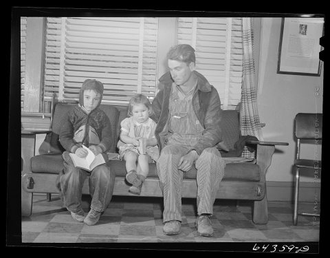 Chafee, Missouri. Father and children waiting to see the doctor. The little girl was bitten by a dog and is to receive …